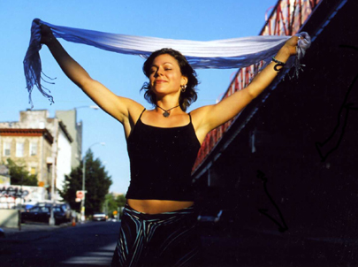 Picture of exultant woman by NYC bridge