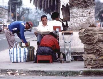 Shoeshine on main street, Ibarra, north of Otavalo, 1984