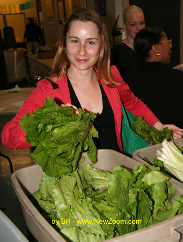 Picture of a women choosing lettuce at a CSA June 2009